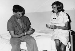 Jennifer Young playing cards with a soldier