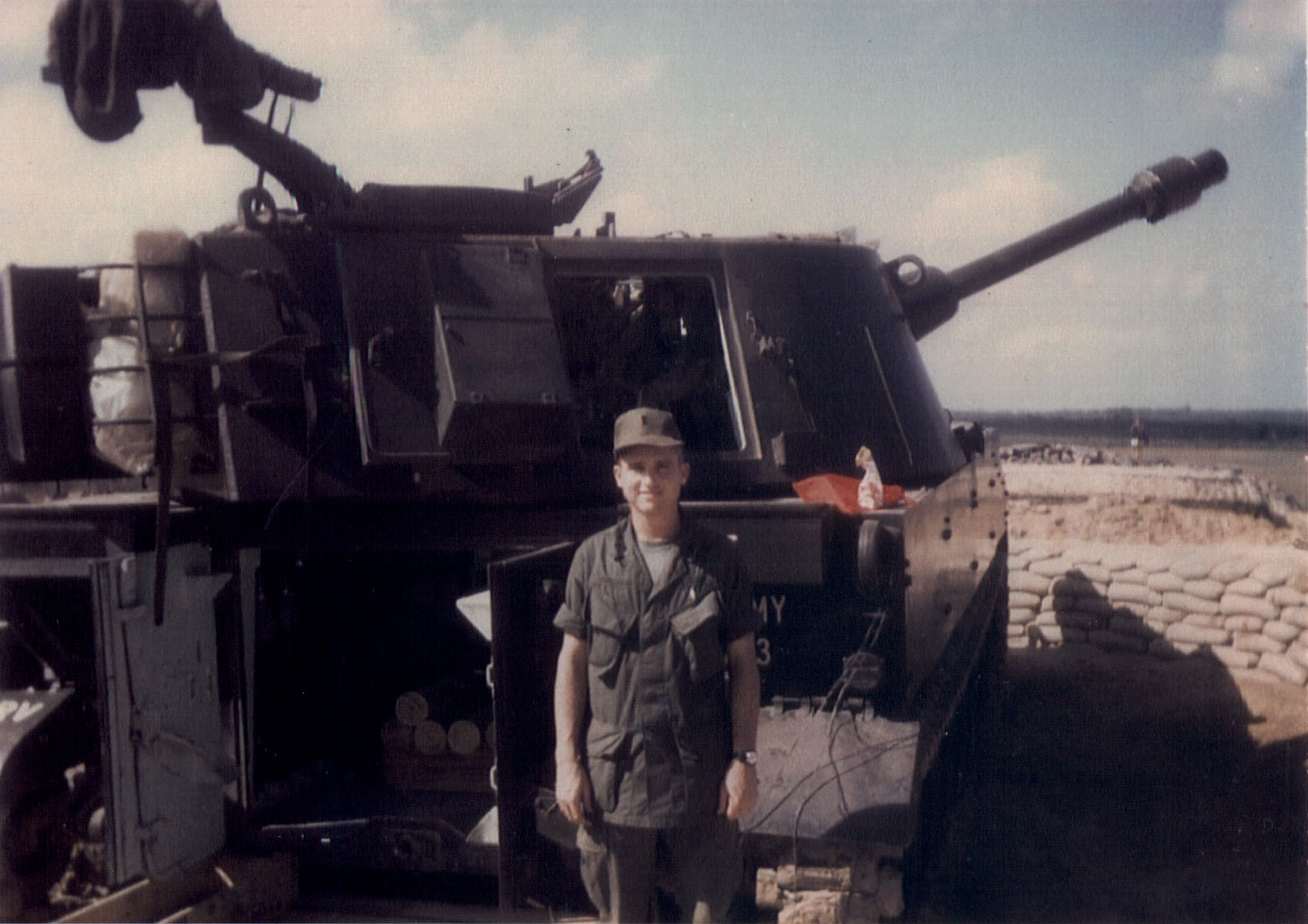 Patterson standing in front of a 105 self propelled Howitzer. 