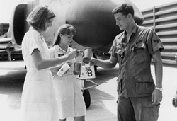 Jennifer Young and a fellow Donut Dolly pouring a drink for a soldier