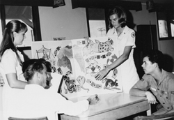 Jennifer Young and a fellow Donut Dolly play a game with the troops